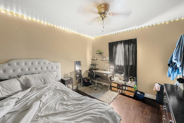 bedroom featuring baseboards and wood-type flooring