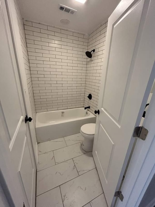 bathroom with visible vents, toilet, marble finish floor, and bathtub / shower combination