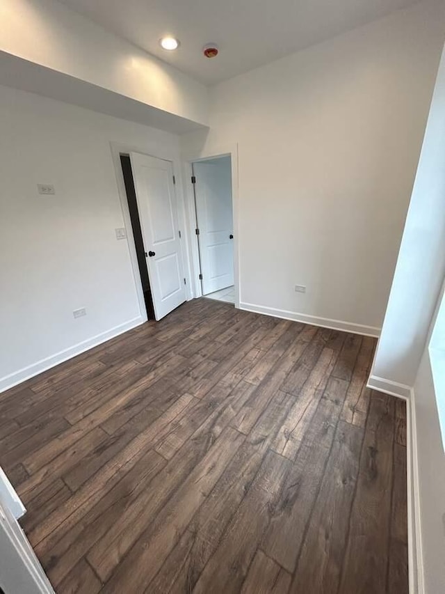 interior space with dark wood finished floors, recessed lighting, and baseboards