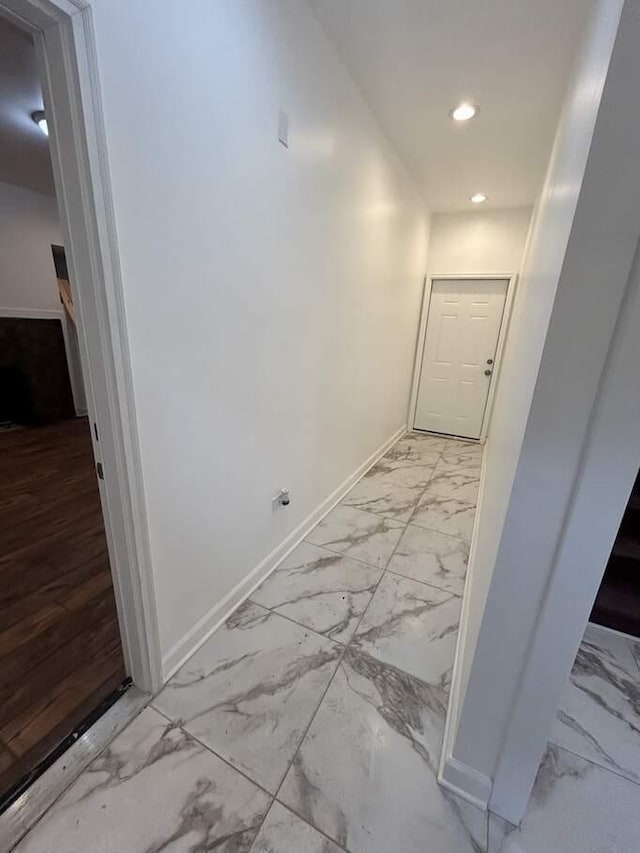 hallway with recessed lighting, baseboards, and marble finish floor