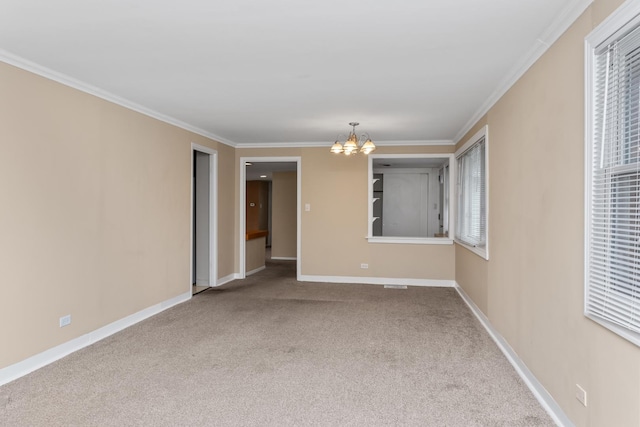 empty room featuring an inviting chandelier, baseboards, carpet floors, and ornamental molding