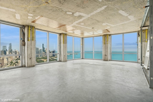 unfurnished sunroom with a view of city and a wealth of natural light