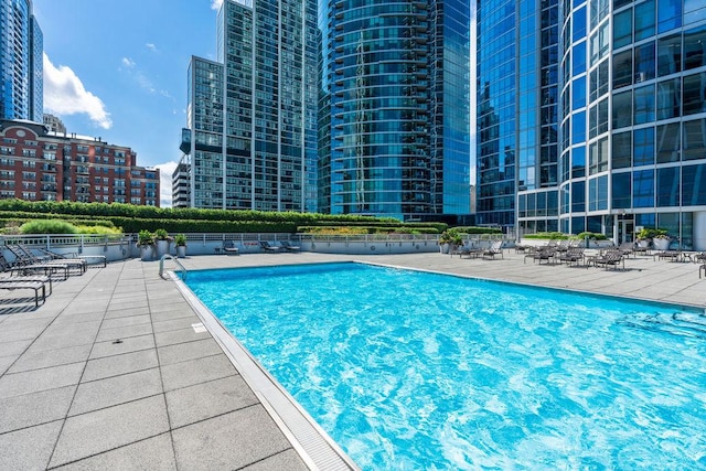 pool featuring a patio and a view of city