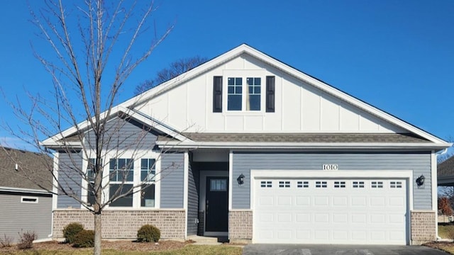 craftsman-style house with brick siding, driveway, and board and batten siding