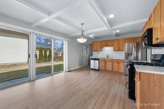 kitchen with black microwave, dishwasher, gas range oven, coffered ceiling, and a sink