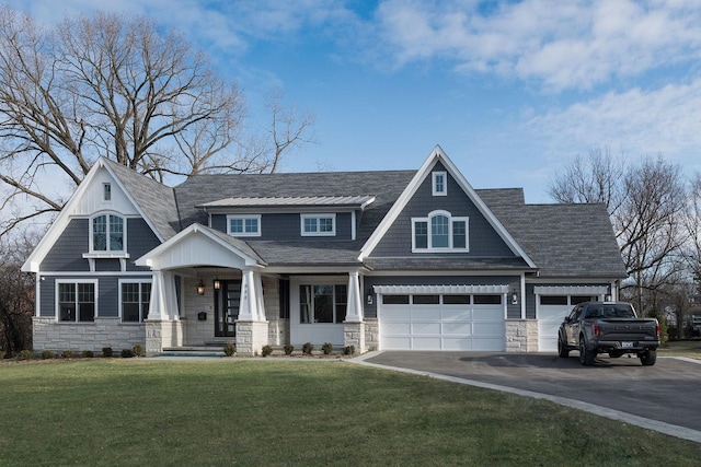 511 N Branch Rd, Glenview, IL 60025 - craftsman-style home featuring a porch, a front yard, driveway, and stone siding