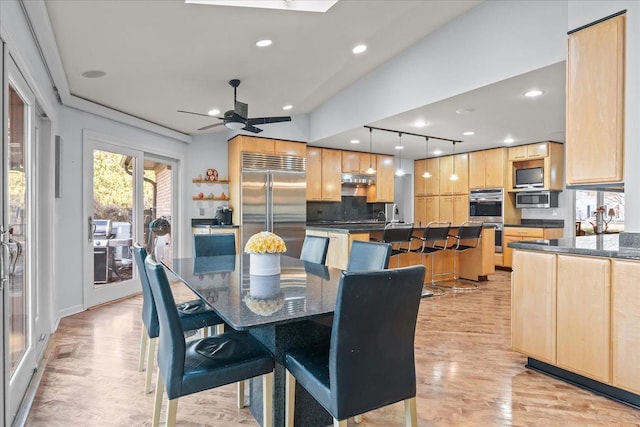 dining room with recessed lighting, rail lighting, a ceiling fan, and light wood-style floors