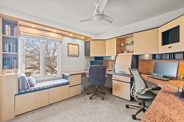 office space with light colored carpet and ceiling fan