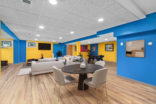 dining space featuring visible vents, wood finished floors, recessed lighting, a paneled ceiling, and baseboards