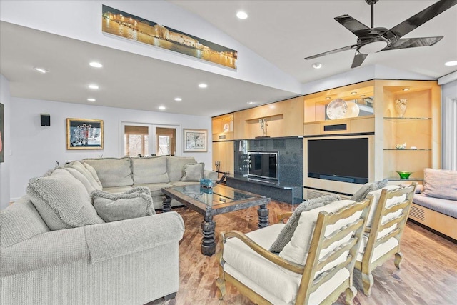 living room featuring vaulted ceiling, recessed lighting, ceiling fan, and wood finished floors