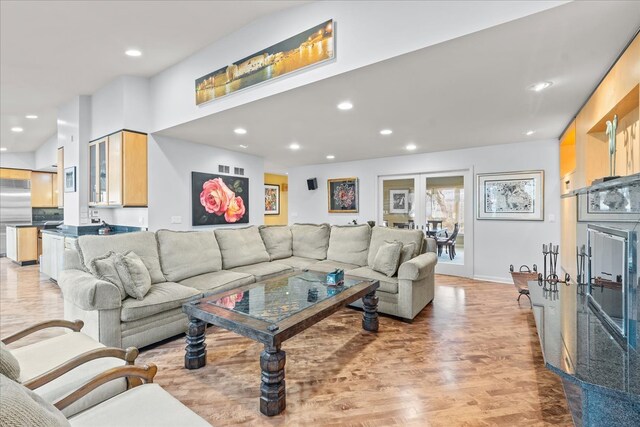 living area featuring recessed lighting, light wood-style floors, and baseboards