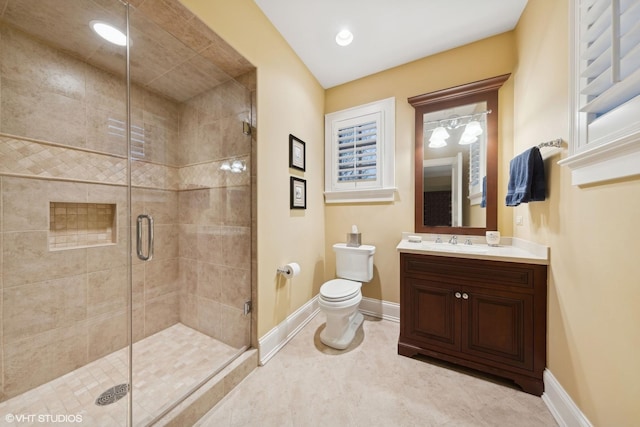 bathroom with vanity, baseboards, tile patterned flooring, a shower stall, and toilet