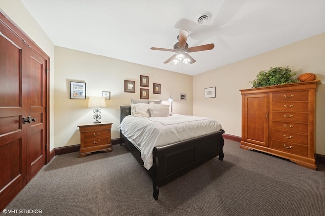 bedroom with visible vents, dark colored carpet, and baseboards