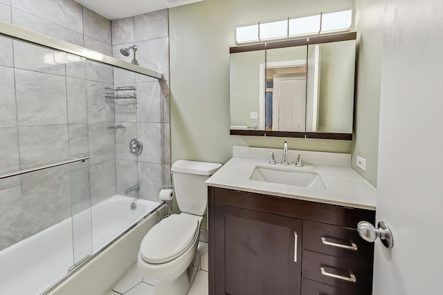 full bath with vanity, toilet, and shower / bath combination with glass door