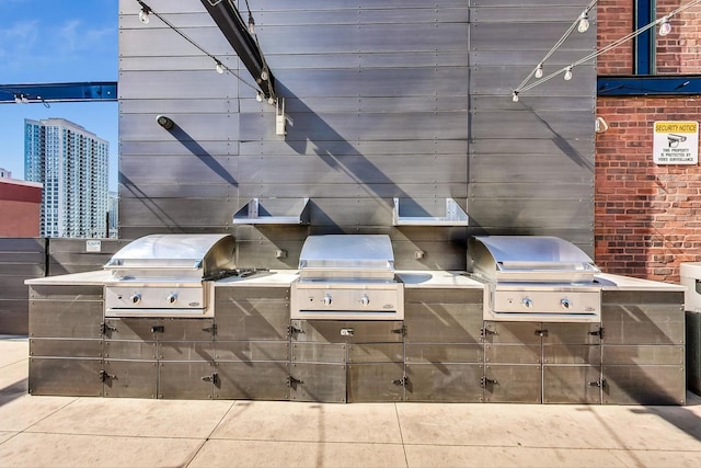 view of patio / terrace featuring area for grilling, a grill, and a view of city