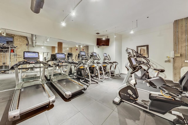 workout area featuring track lighting