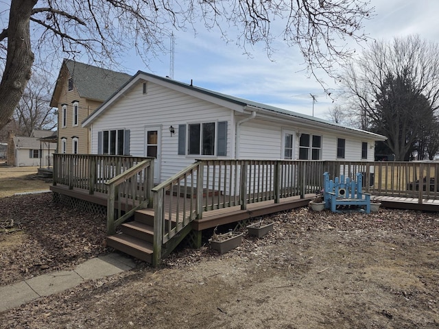 back of property featuring a deck