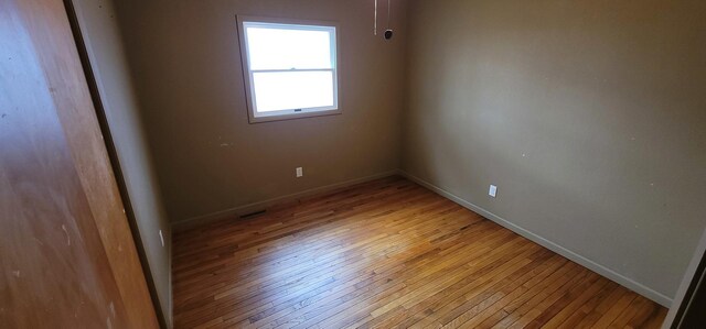 spare room with visible vents, baseboards, and light wood-style floors