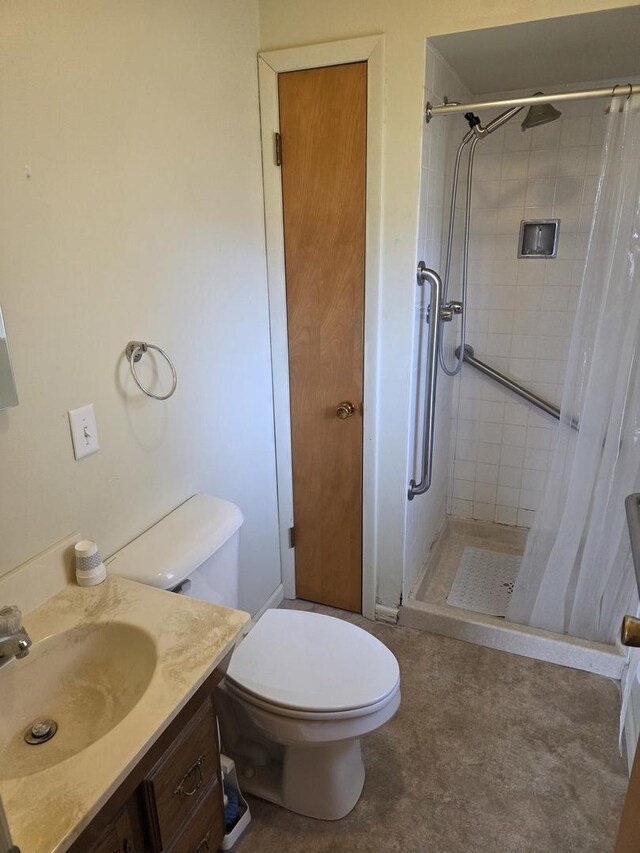 full bath with toilet, a stall shower, and vanity