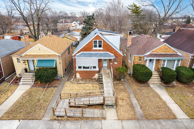 view of front of home with a residential view and brick siding