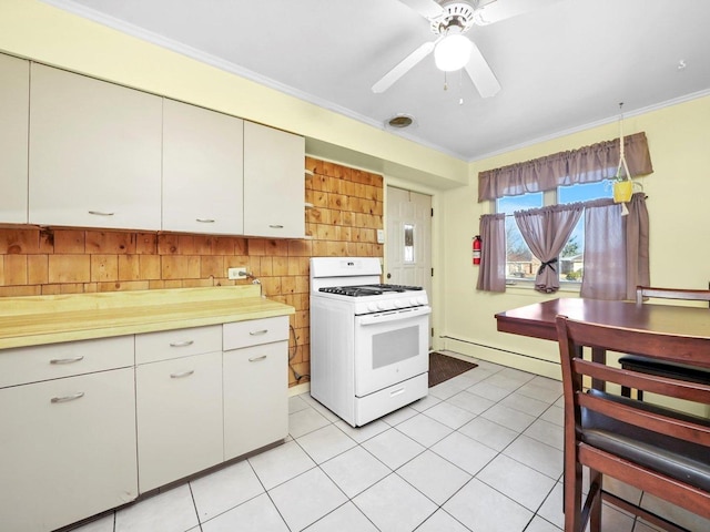kitchen featuring light tile patterned floors, a baseboard radiator, white range with gas cooktop, light countertops, and crown molding