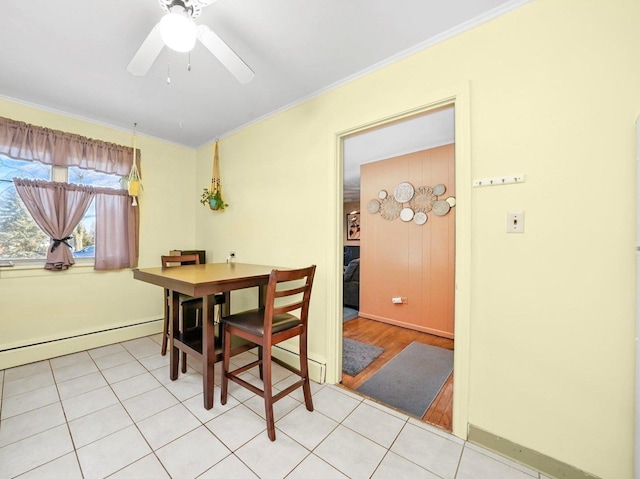dining room with light tile patterned floors, baseboards, baseboard heating, and crown molding