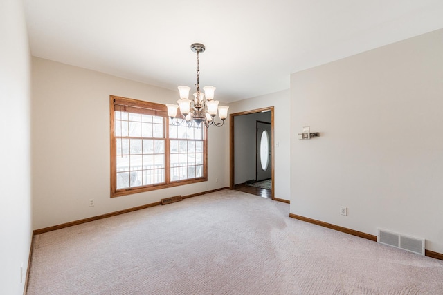 carpeted empty room with an inviting chandelier, baseboards, and visible vents