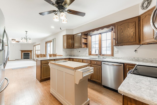 kitchen with plenty of natural light, light wood-style floors, appliances with stainless steel finishes, and a sink