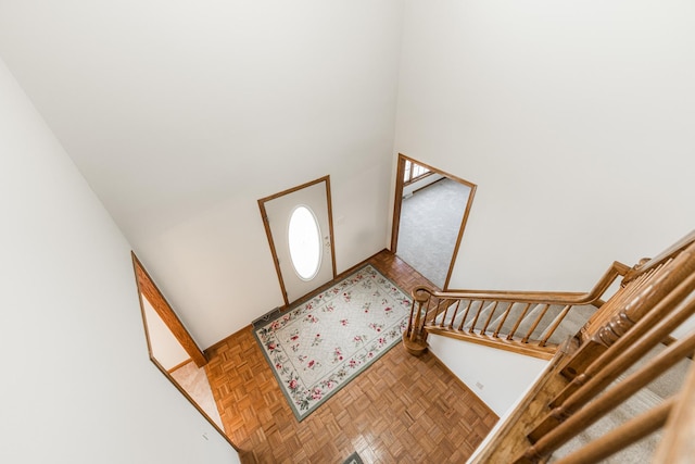 foyer entrance with a high ceiling and stairs