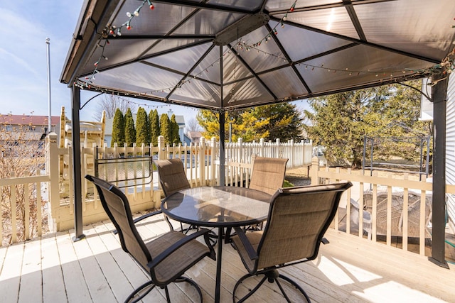 wooden deck featuring outdoor dining area and fence