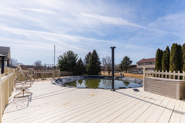 view of swimming pool featuring a fenced in pool, a deck, and fence