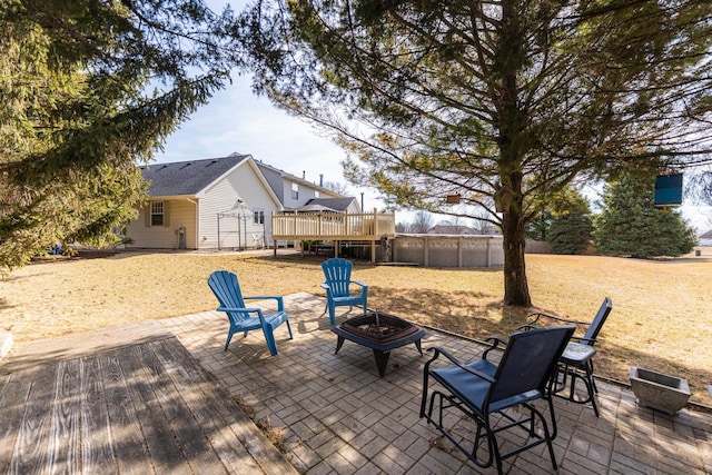 view of patio / terrace with a wooden deck and a fire pit