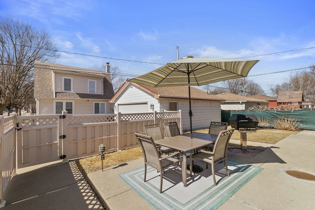 view of patio with outdoor dining space, a gate, and fence