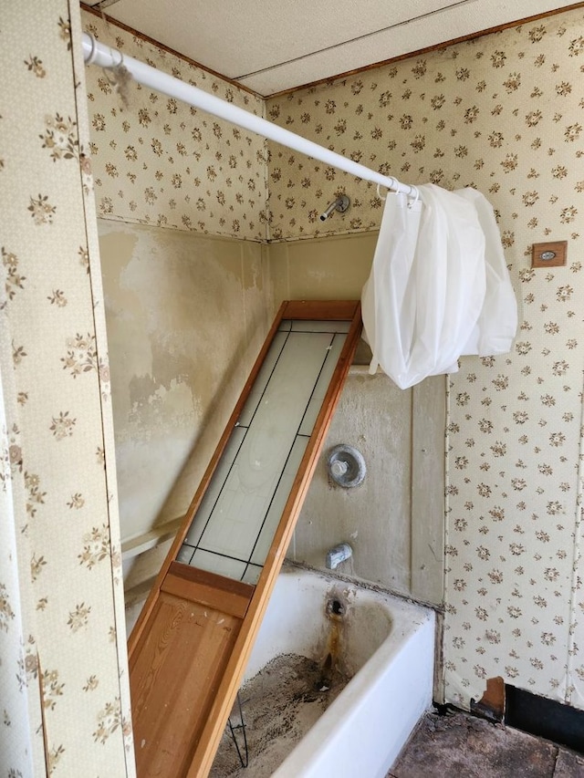 bathroom with a bathing tub and wallpapered walls