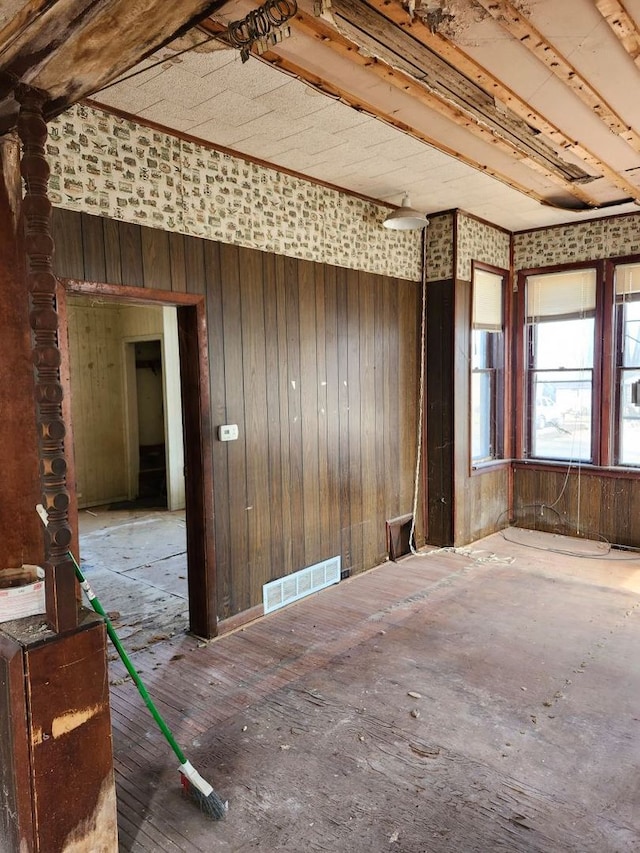 misc room with visible vents and wooden walls