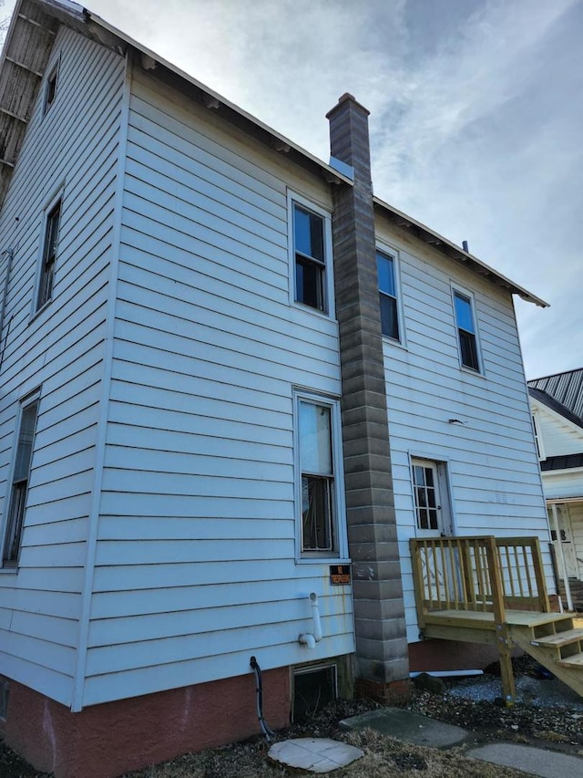 back of property with a chimney