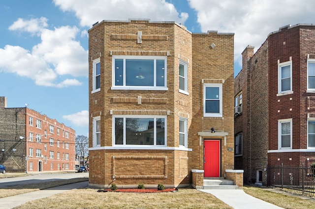 view of front facade featuring entry steps and brick siding