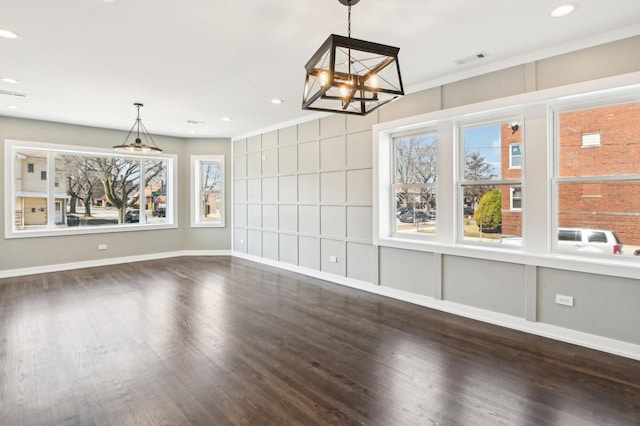 unfurnished dining area with recessed lighting, visible vents, baseboards, and wood finished floors