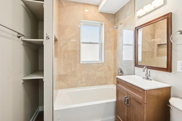 bathroom featuring toilet, vanity, and shower / bath combination