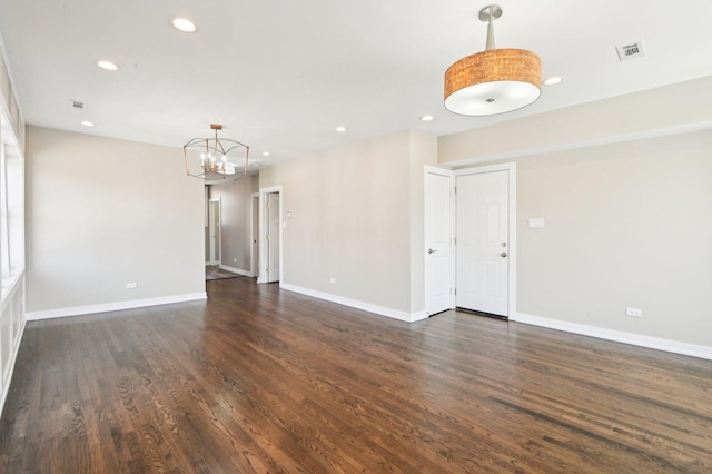 unfurnished room with dark wood finished floors, an inviting chandelier, recessed lighting, and baseboards