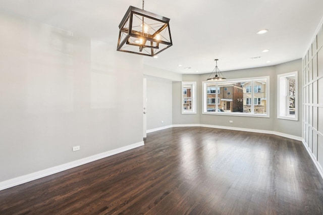 interior space featuring dark wood finished floors, a chandelier, recessed lighting, and baseboards