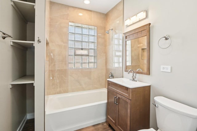 full bathroom featuring baseboards, toilet, bathing tub / shower combination, wood finished floors, and vanity