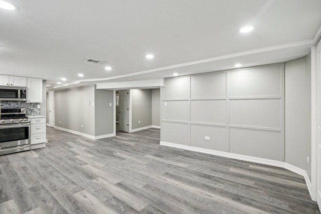 interior space with visible vents, recessed lighting, light countertops, light wood-style floors, and appliances with stainless steel finishes