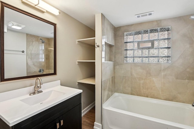 full bathroom with visible vents, vanity, bathing tub / shower combination, and wood finished floors