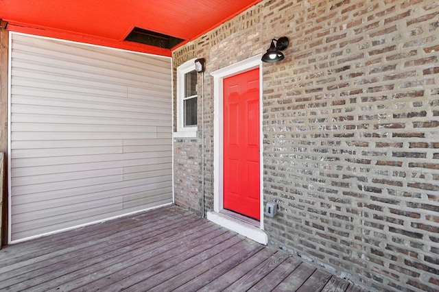 property entrance featuring brick siding