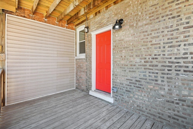 doorway to property featuring brick siding