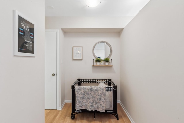 sitting room with baseboards and wood finished floors