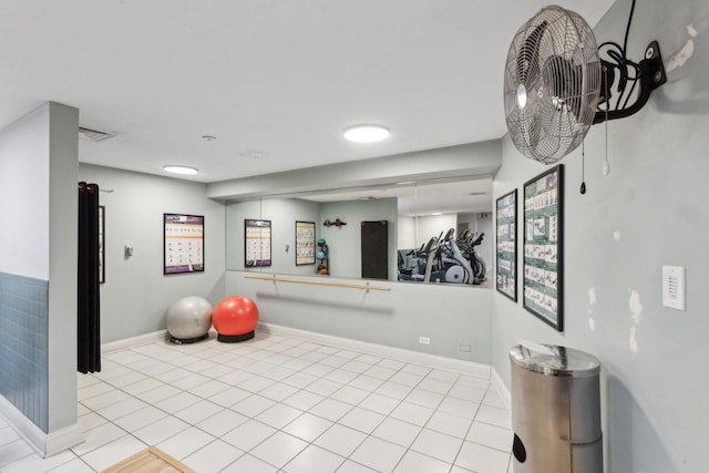 exercise area featuring tile patterned floors, visible vents, and baseboards