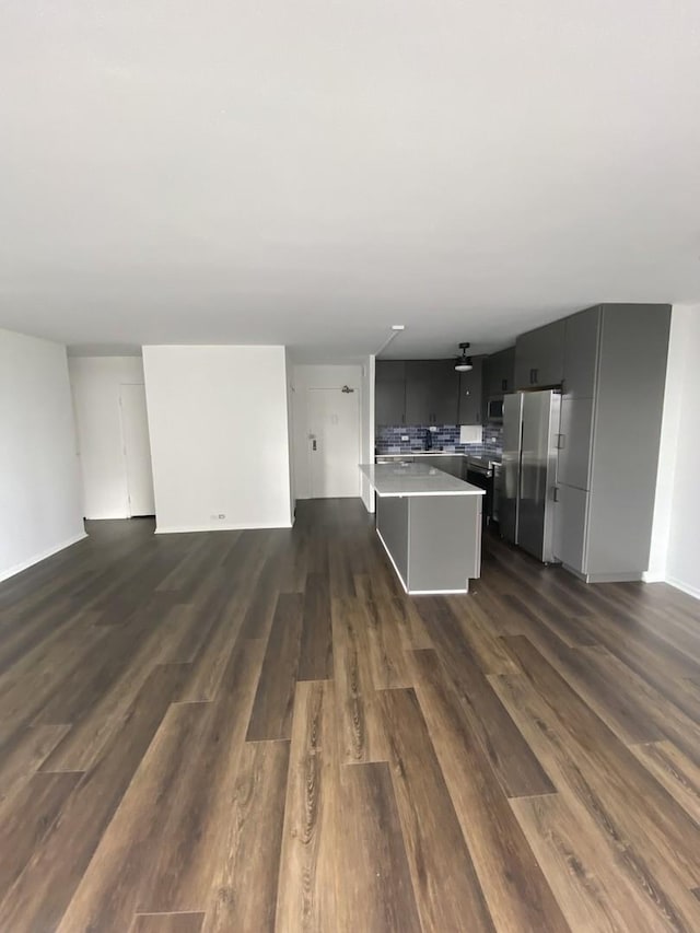 unfurnished living room with dark wood finished floors