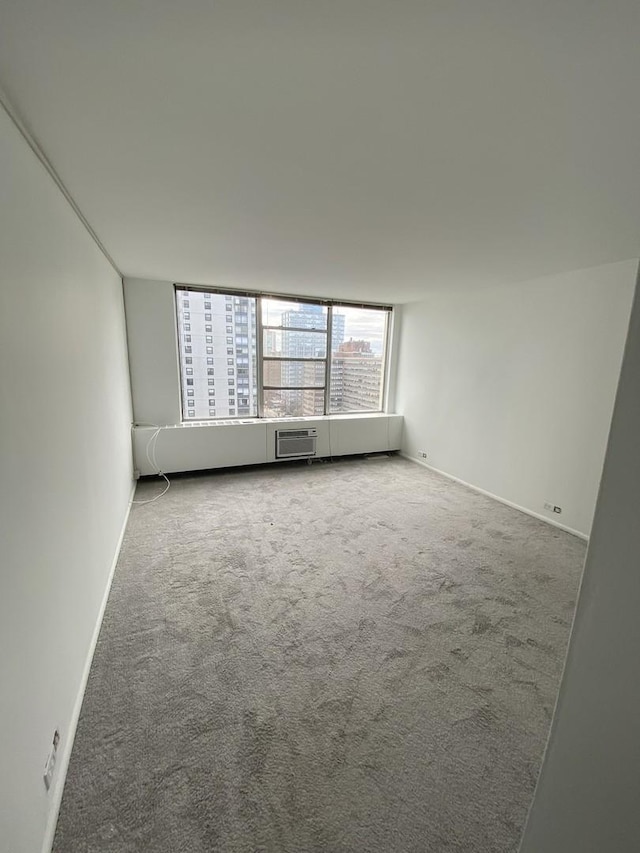 unfurnished room featuring baseboards and carpet flooring